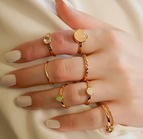 Hand adorned with multiple elegant gold rings