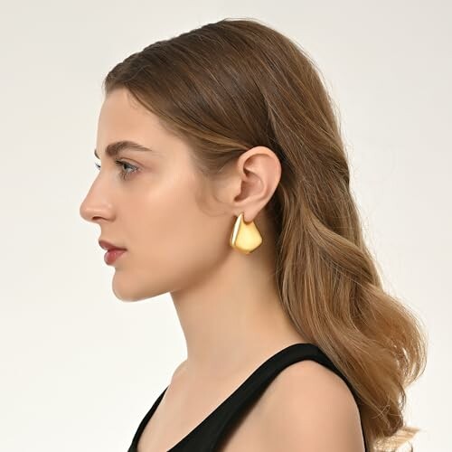 Woman in profile wearing a gold earring